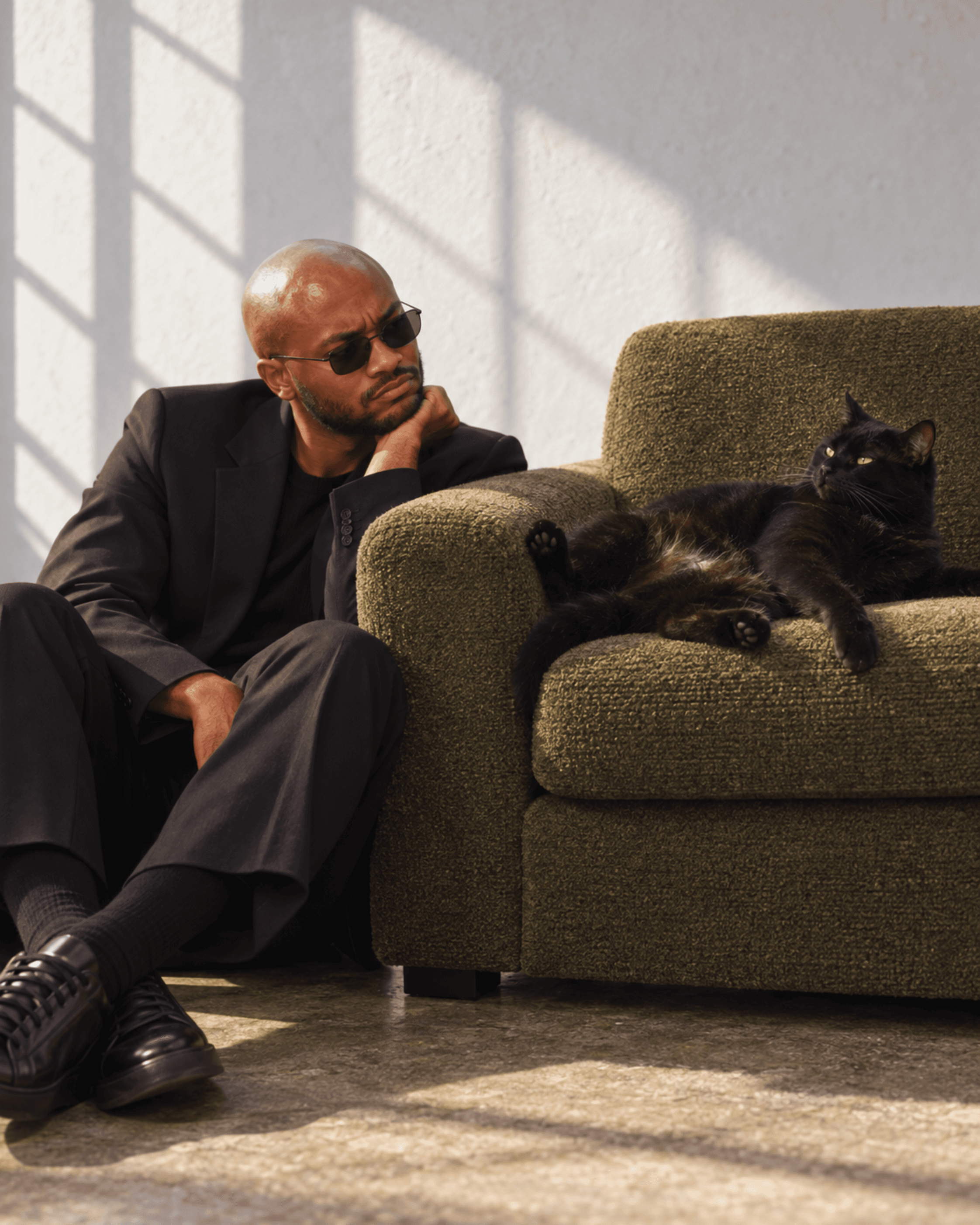 Muiz in black tailoring with a black cat, image 2